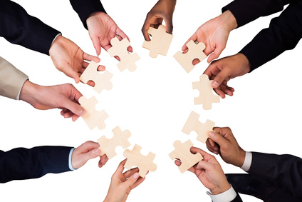 Businesspeople Hand Holding Jigsaw Puzzle High Angle View Of A Businesspeople Hand Holding Jigsaw Puzzle On White Background